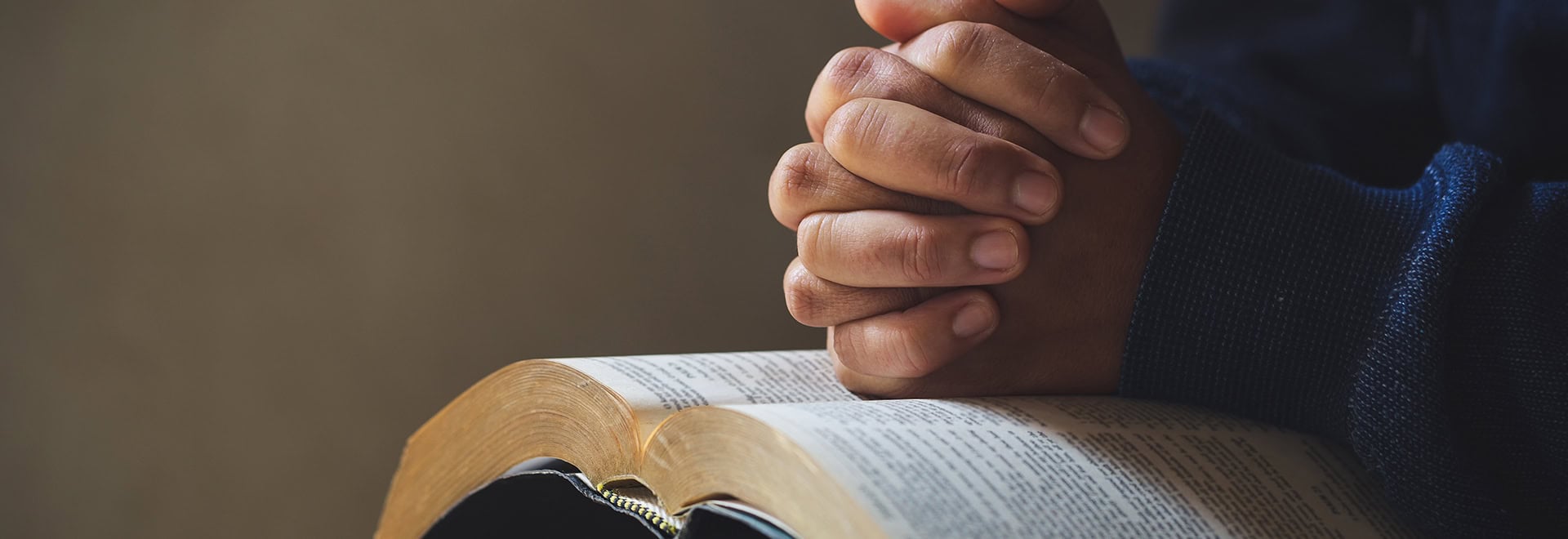 person praying over bible